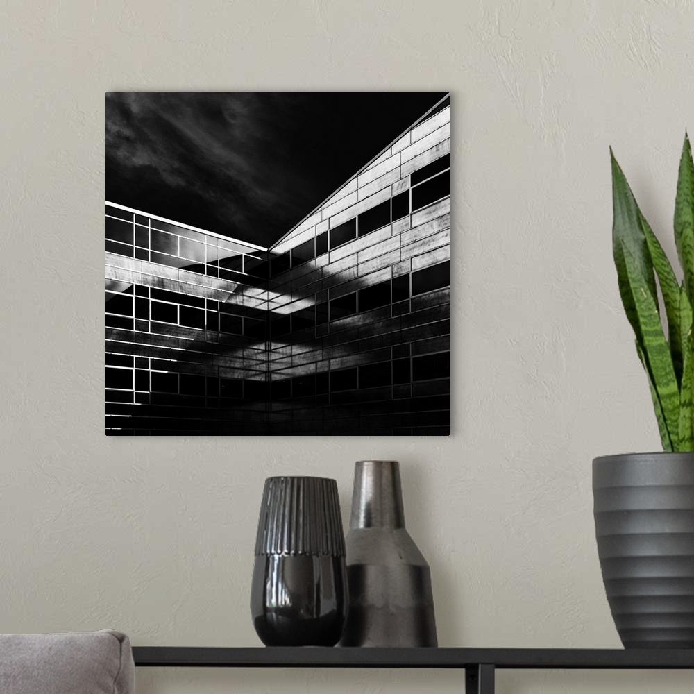A modern room featuring Square black and white architectural photograph of a building facade.