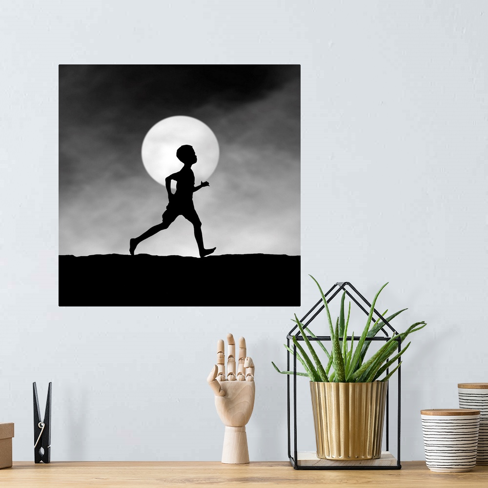 A bohemian room featuring Silhouette of a boy running at night, in front of the full moon.