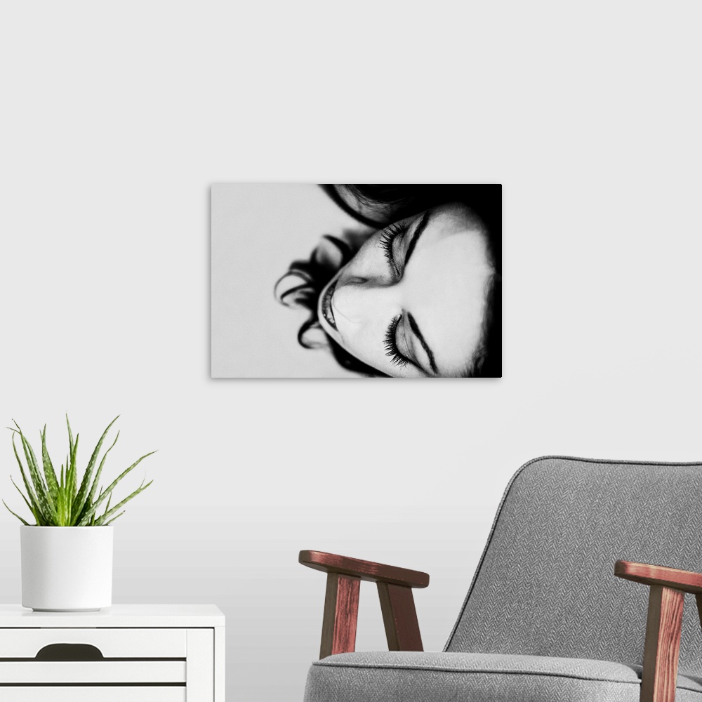 A modern room featuring Black and white photograph of a women's face close-up.
