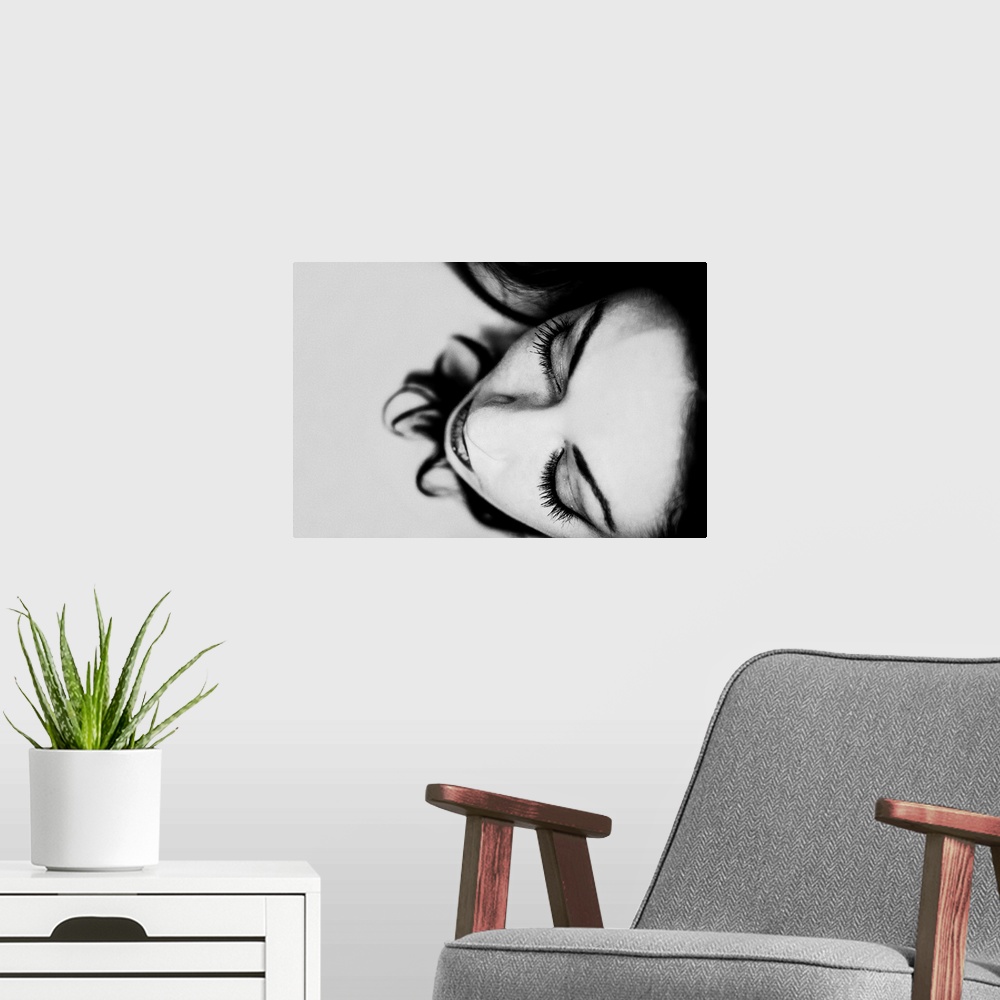 A modern room featuring Black and white photograph of a women's face close-up.