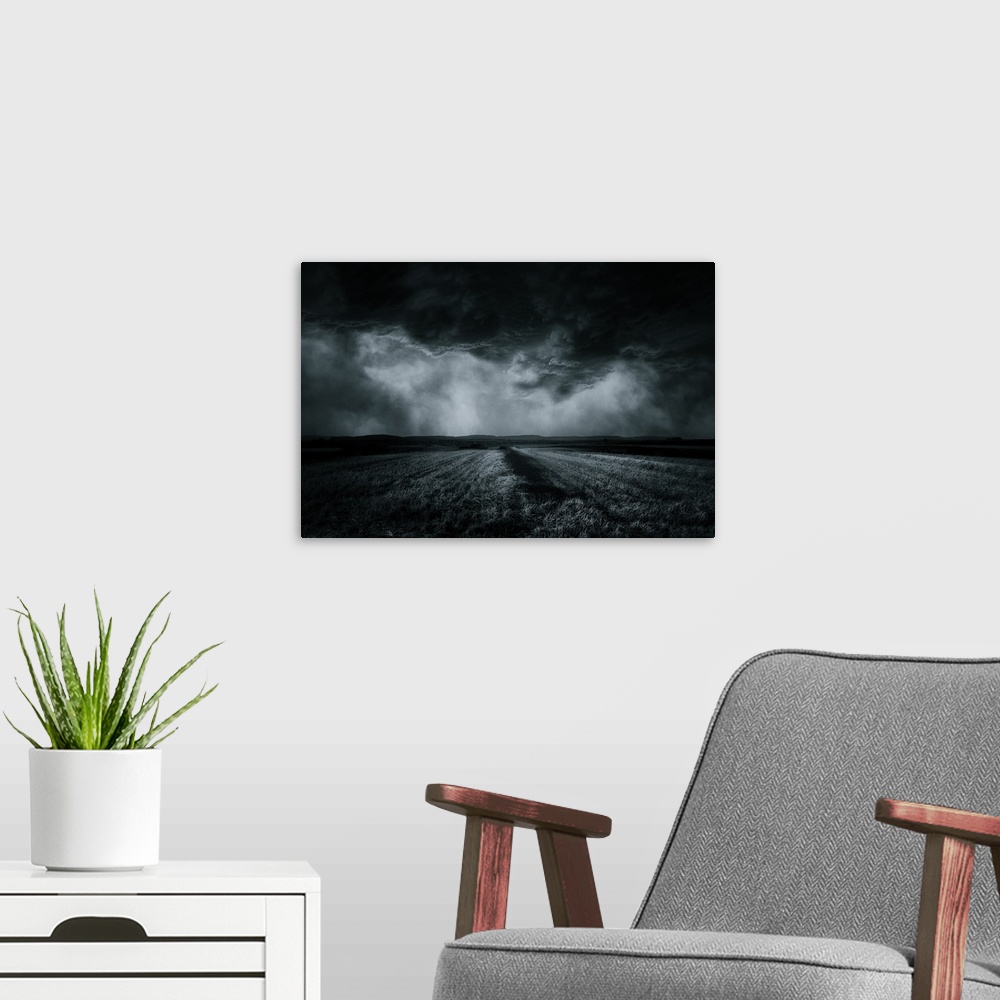 A modern room featuring An ethereal field in the countryside under a blanket of menacing clouds.