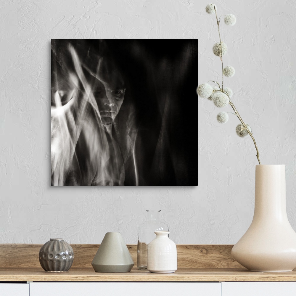 A farmhouse room featuring Square black and white surreal photograph of a man's face in the background with abstract smoke a...