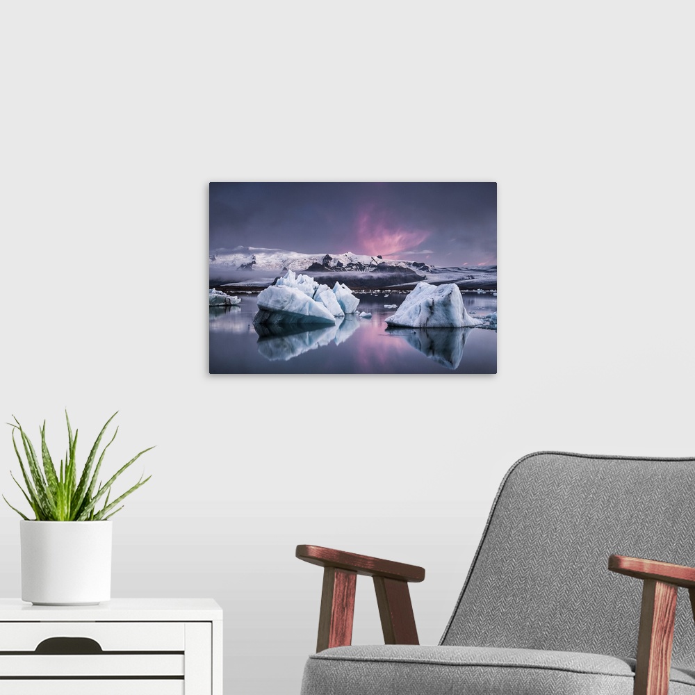 A modern room featuring Large glaciers in the water with snowy mountains in the distance under a pastel-colored sky, Joku...