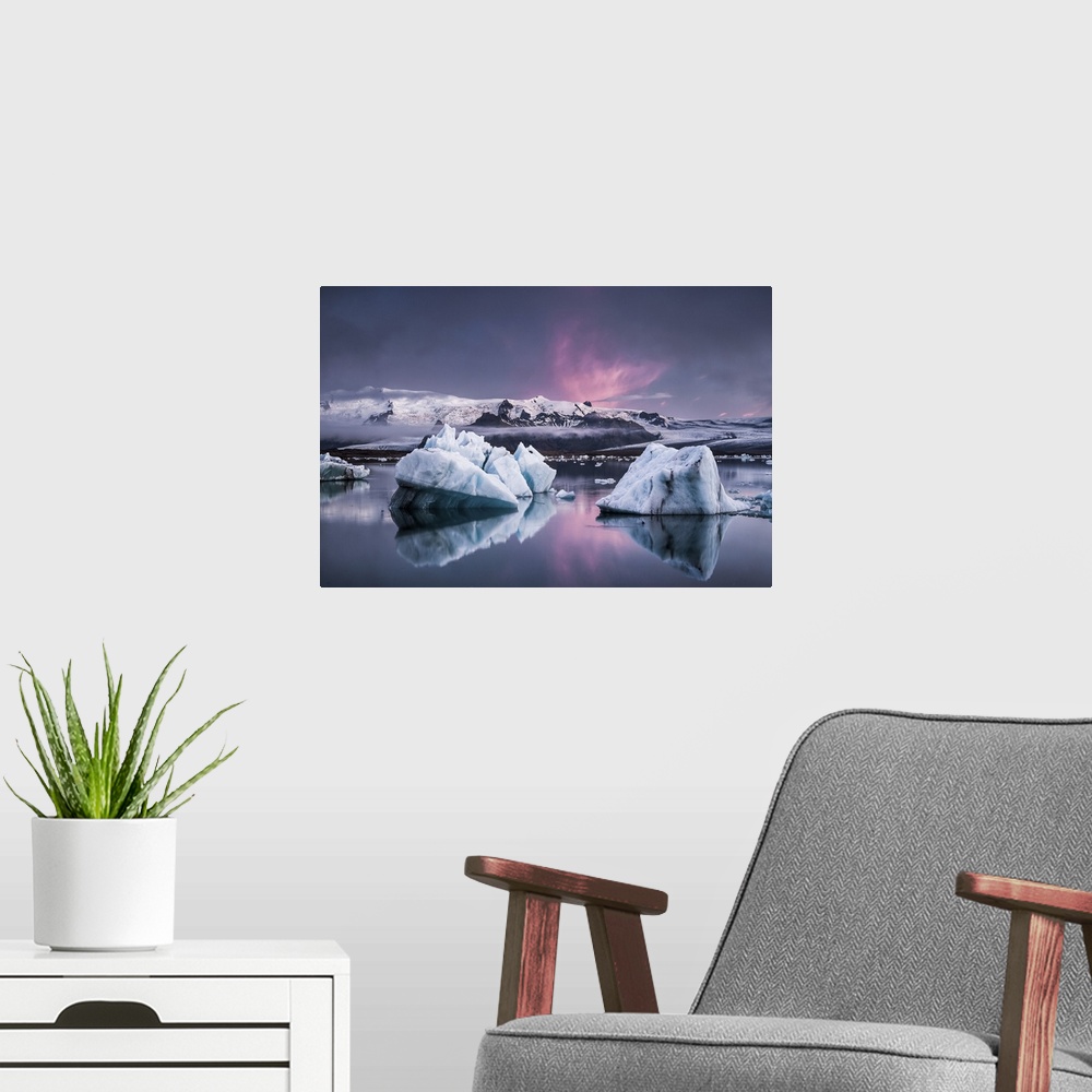A modern room featuring Large glaciers in the water with snowy mountains in the distance under a pastel-colored sky, Joku...