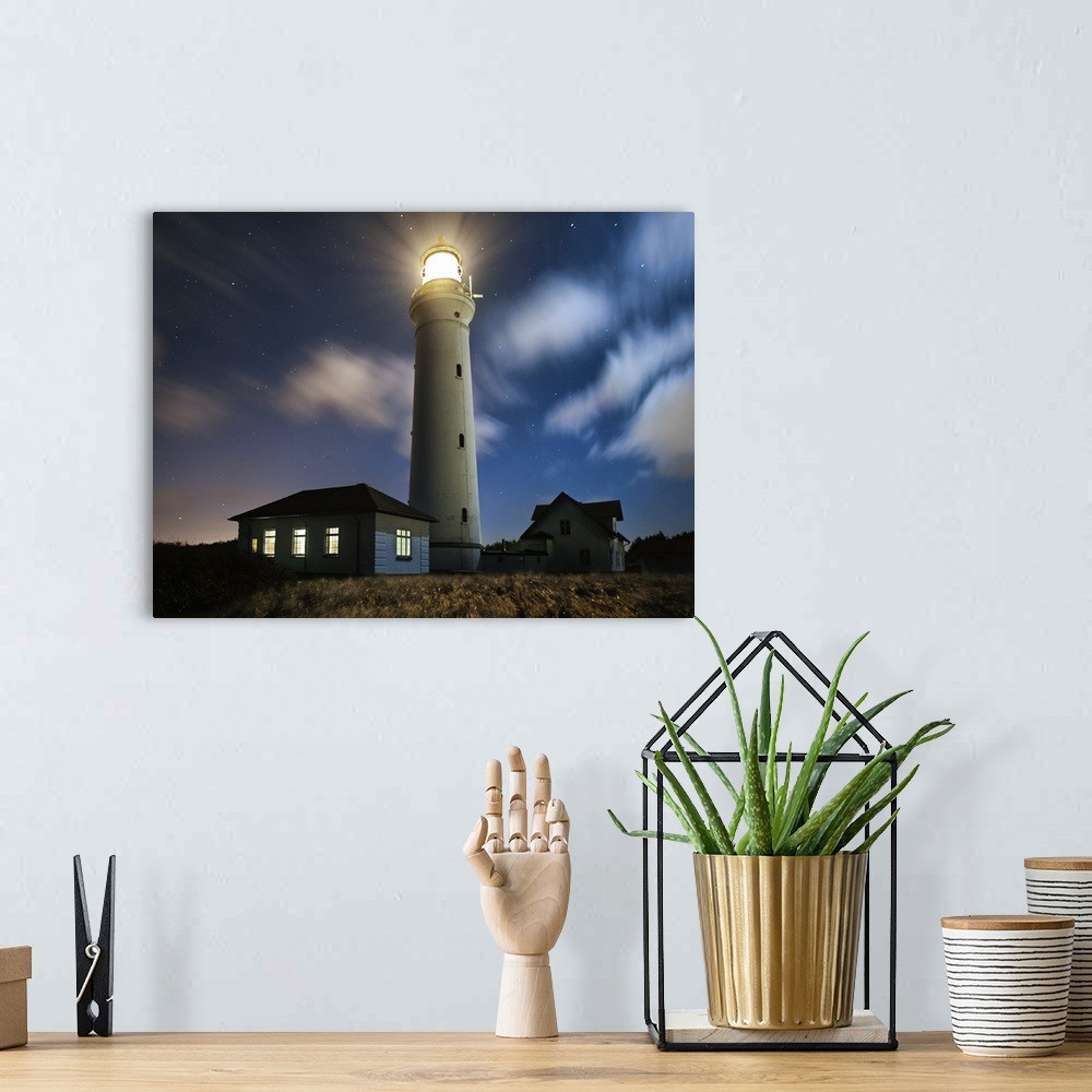 A bohemian room featuring A lighthouse shining on the coast on a starry night.