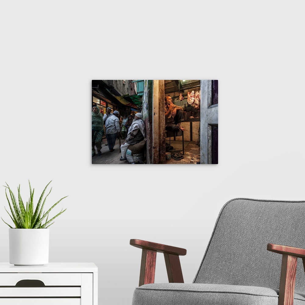 A modern room featuring View of a street in India we contrasting scenes of a busy street and a butcher taking a break in ...