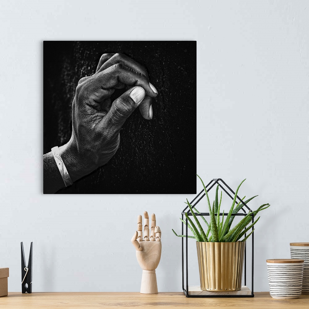 A bohemian room featuring A portrait of a hand in profile against a wall.