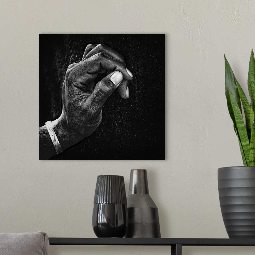 A modern room featuring A portrait of a hand in profile against a wall.