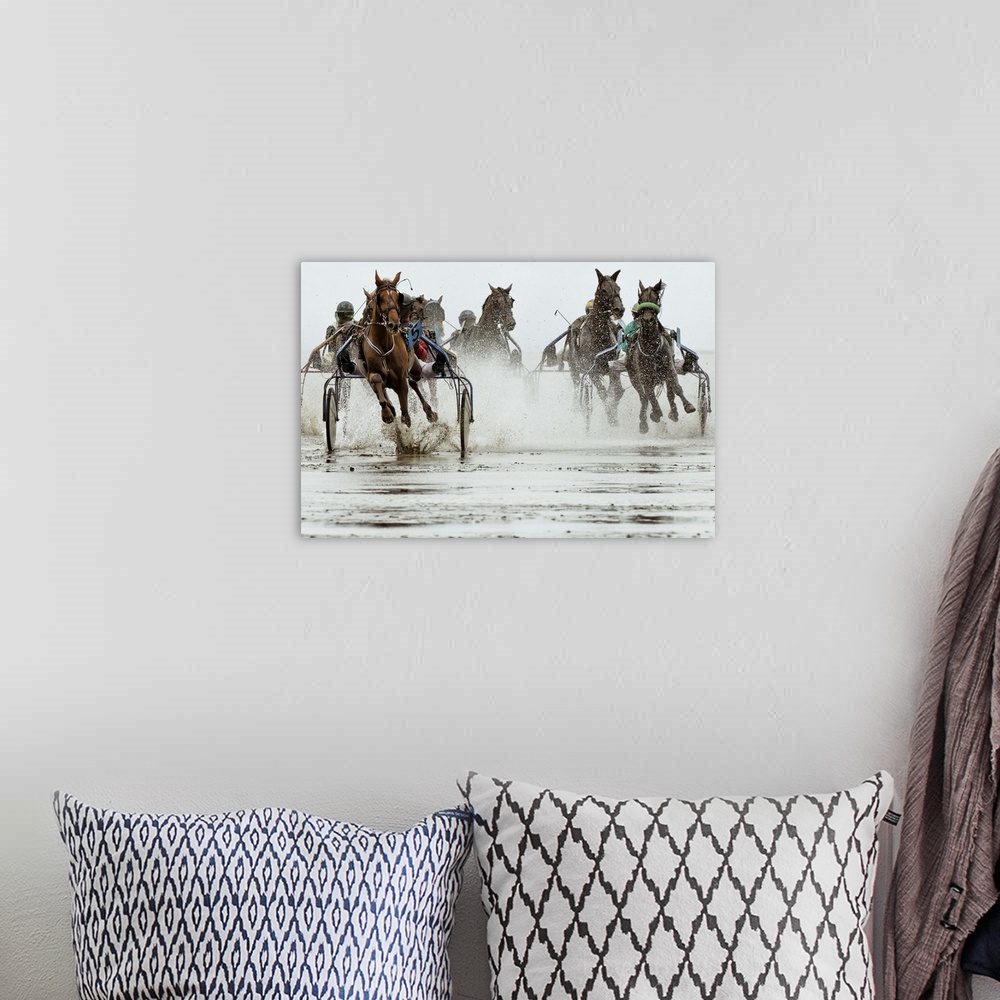 A bohemian room featuring Action shot of a harness race, where horses pull a two-wheeled cart called a sulky.