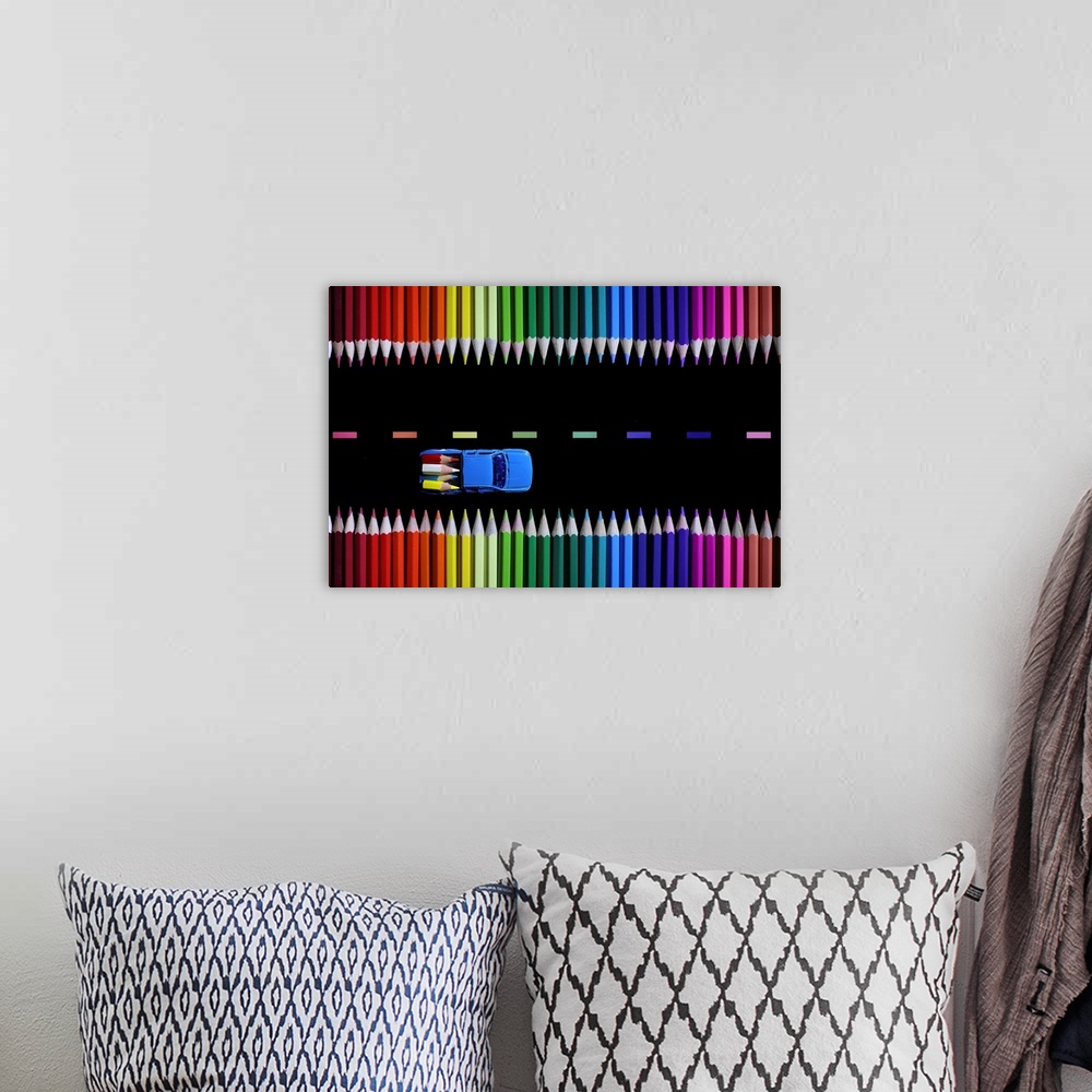 A bohemian room featuring Conceptual photograph of a two truck hauling tiny colored pencils like lumber along a colored pen...