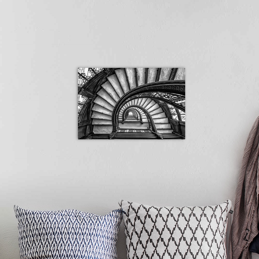 A bohemian room featuring Black and white abstract photograph of a winding staircase.