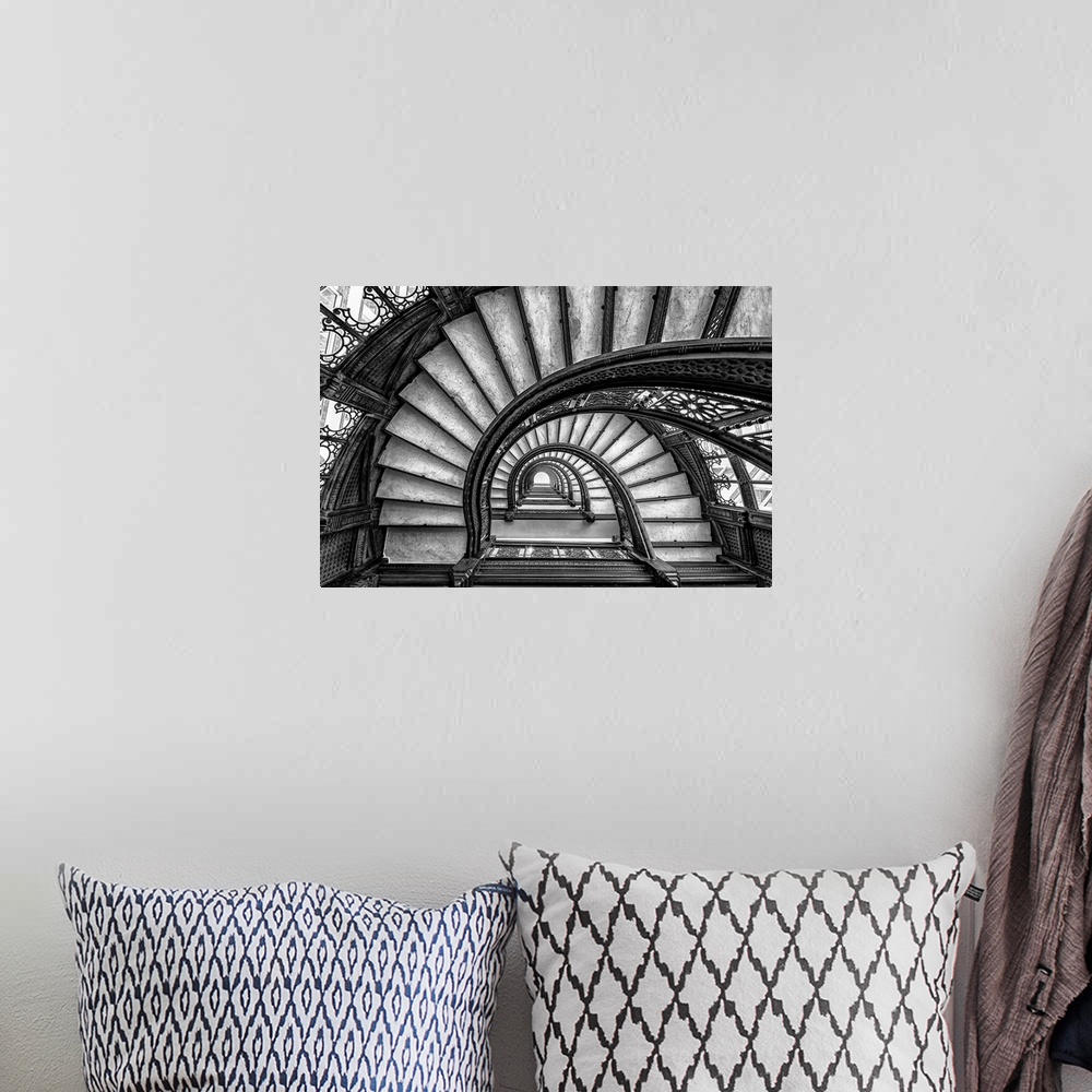 A bohemian room featuring Black and white abstract photograph of a winding staircase.