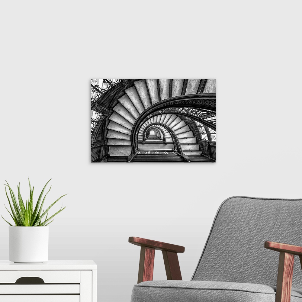 A modern room featuring Black and white abstract photograph of a winding staircase.