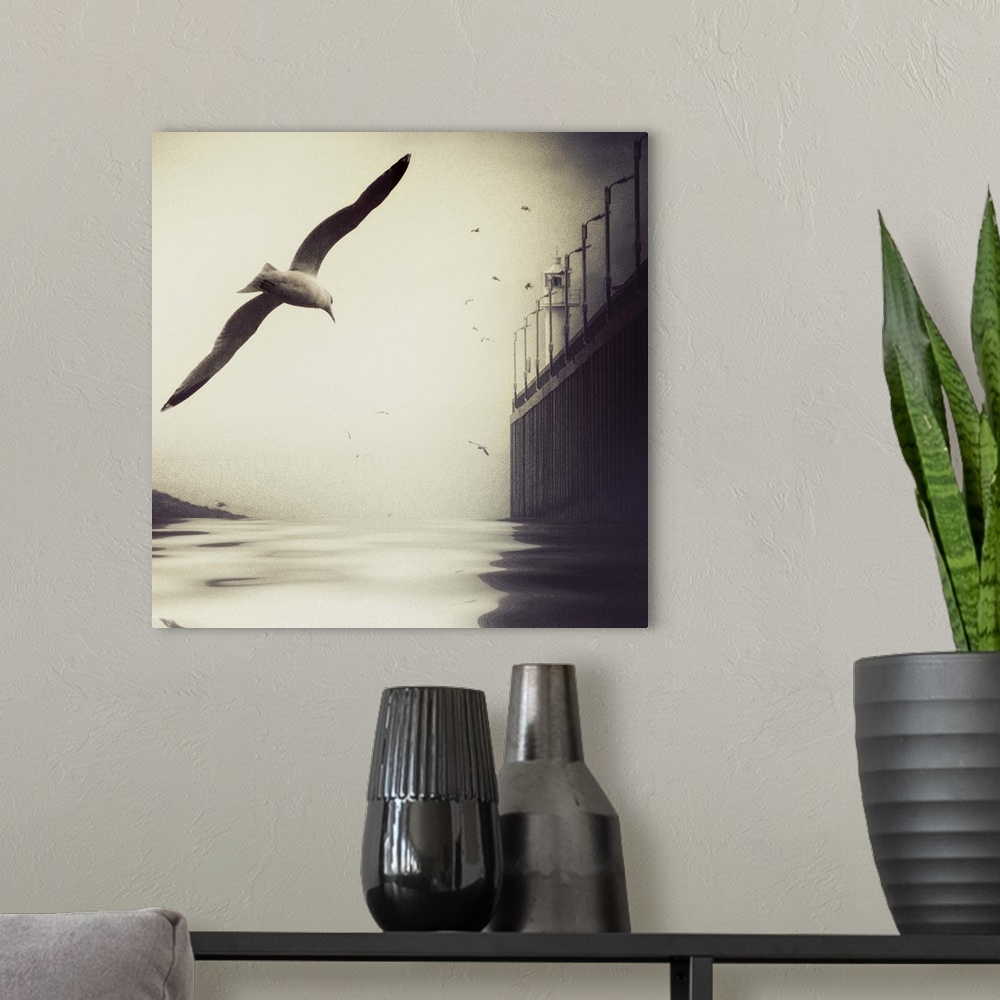 A modern room featuring A seagull flies low over the water, its flock-mates and a lighthouse in the distance.