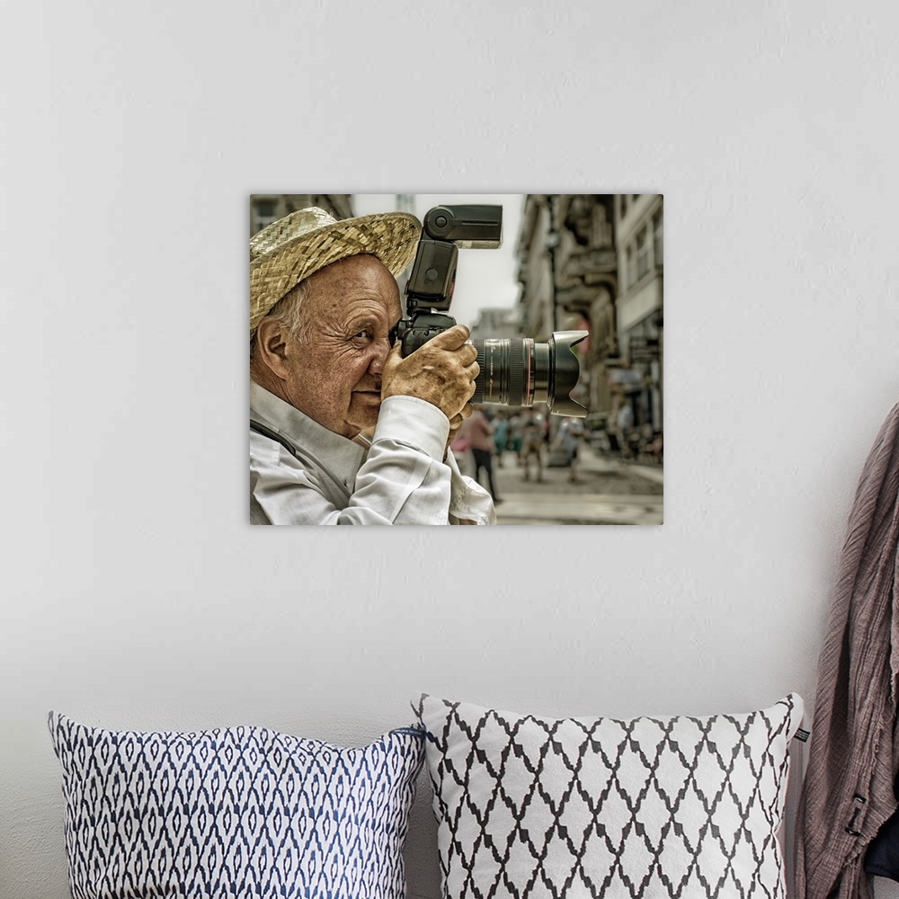 A bohemian room featuring Portrait of an elderly man taking a photo with a large camera, Budapest, Hungary.