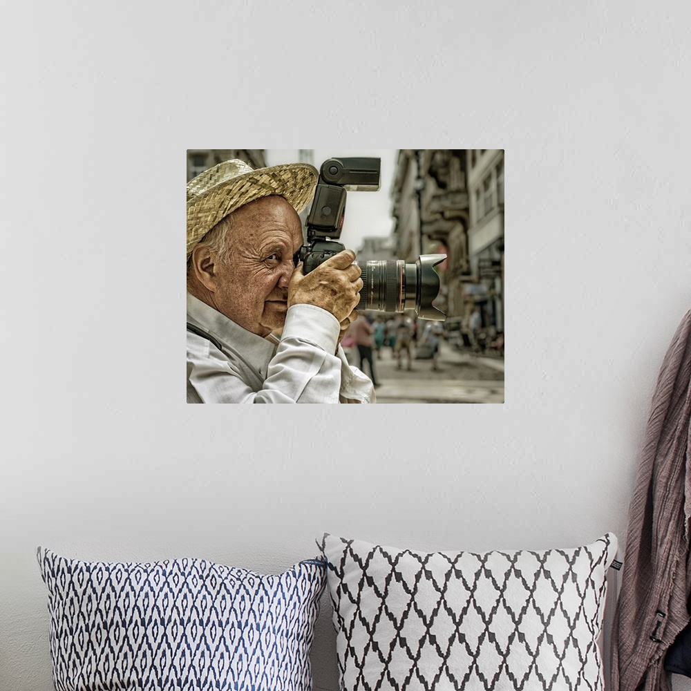 A bohemian room featuring Portrait of an elderly man taking a photo with a large camera, Budapest, Hungary.