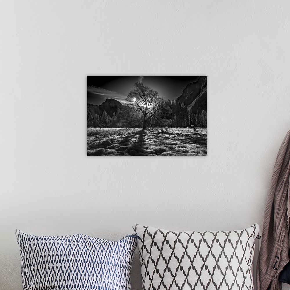 A bohemian room featuring Black and white image of a clearing in Yosemite Valley with the sun low in the sky, and Half Dome...