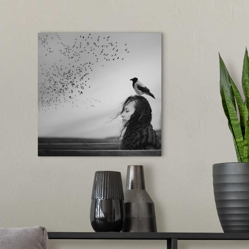 A modern room featuring Black and white portrait of a woman with a magpie standing on her head, looking at a flock of bir...