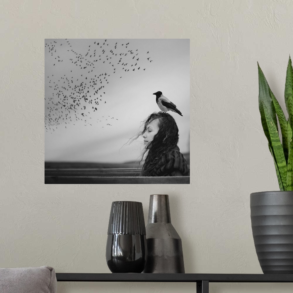 A modern room featuring Black and white portrait of a woman with a magpie standing on her head, looking at a flock of bir...