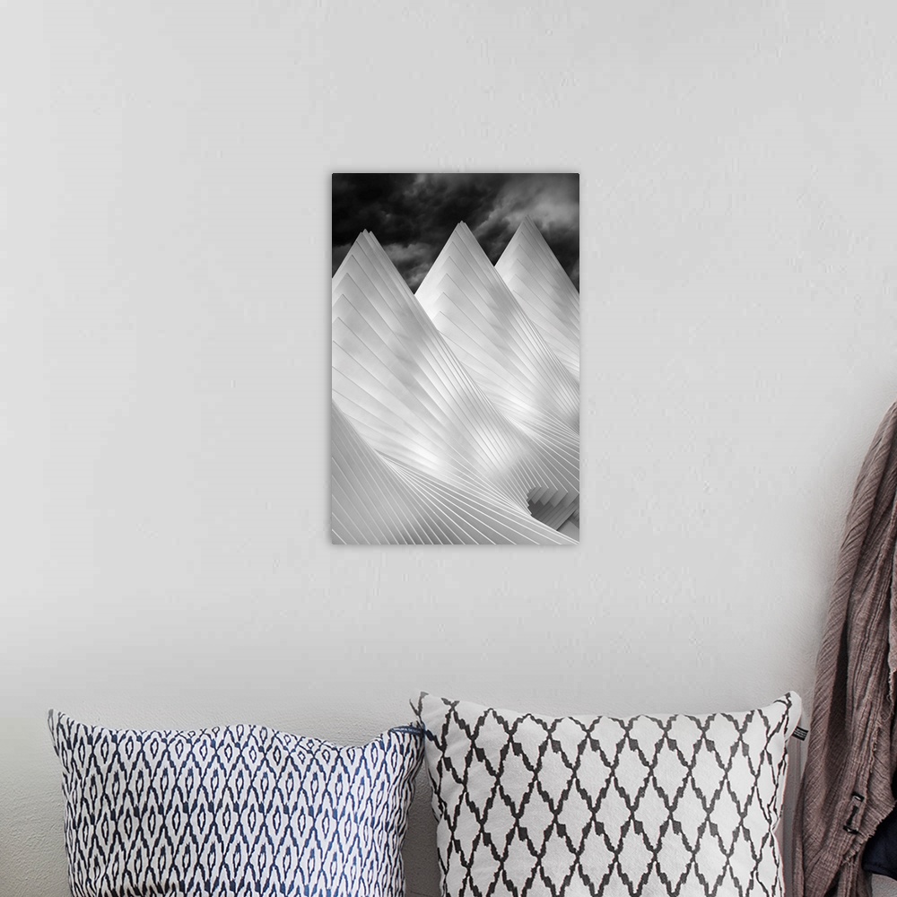 A bohemian room featuring A black and white photograph of conical architectural attributes.