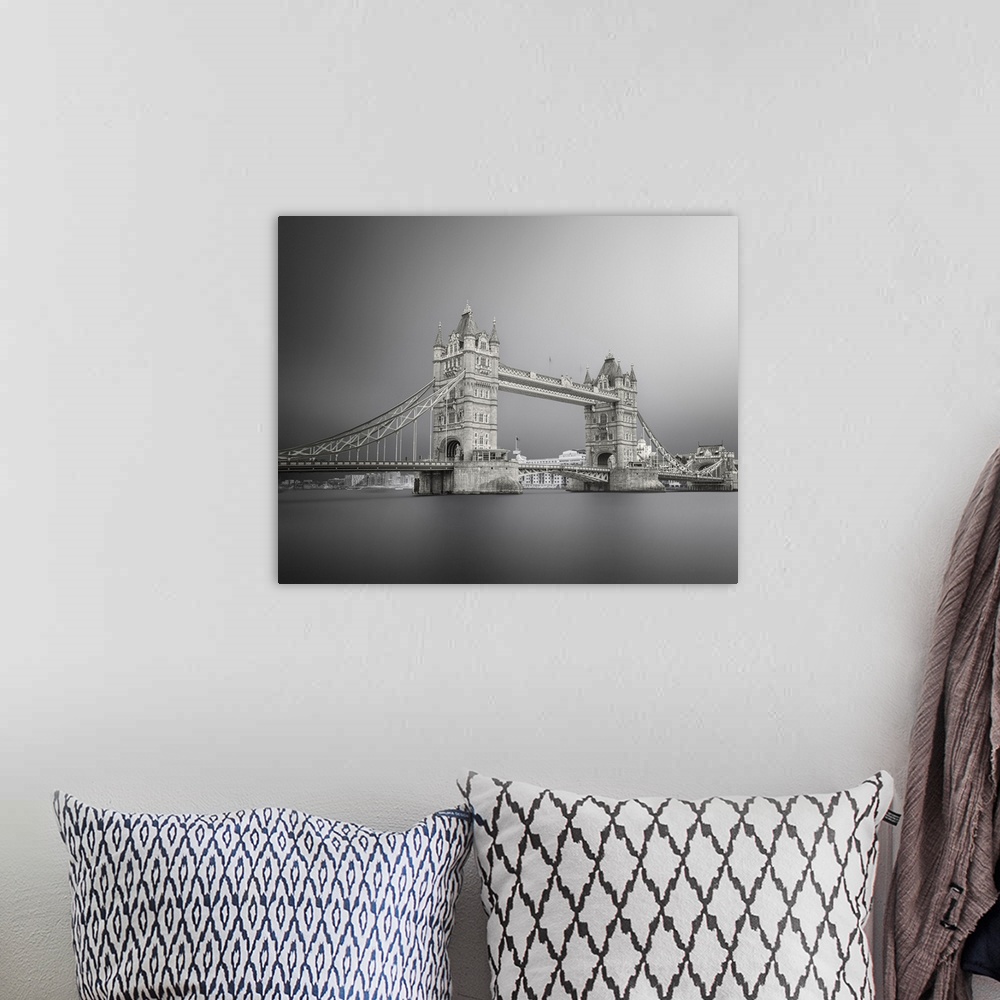 A bohemian room featuring Black and white photograph of Tower Bridge in London with silky, calm water below.