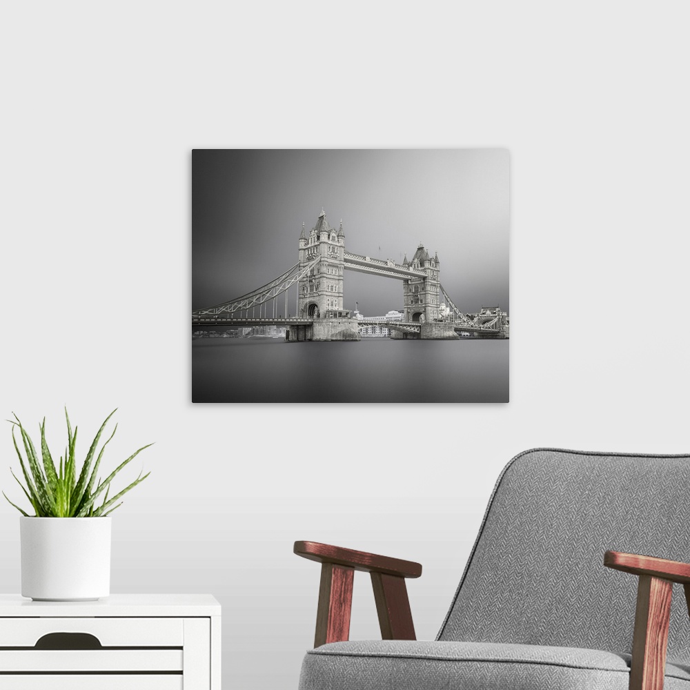 A modern room featuring Black and white photograph of Tower Bridge in London with silky, calm water below.