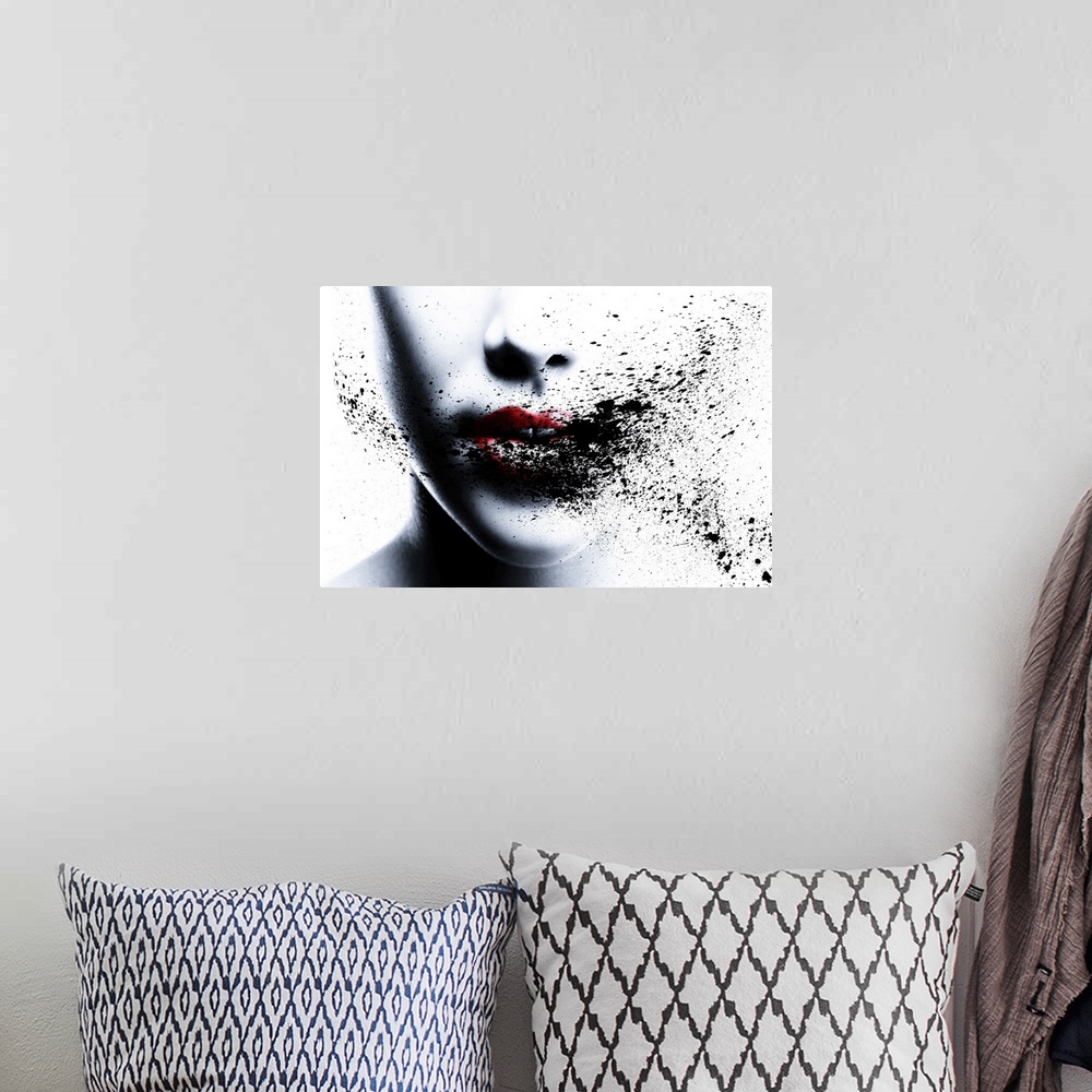 A bohemian room featuring Portrait of a woman with bright red ligps and ink splatters across her face.