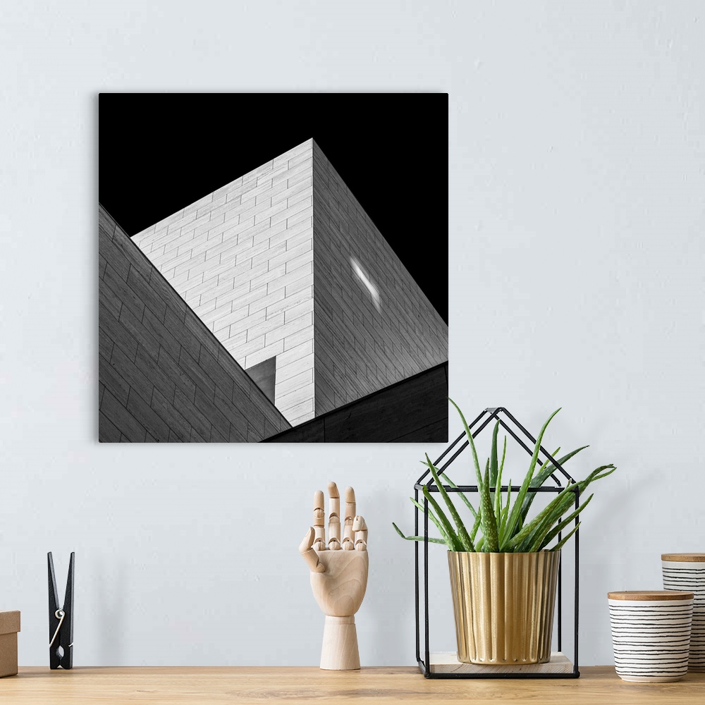 A bohemian room featuring Black and white image of triangular shadows created by a modern building.