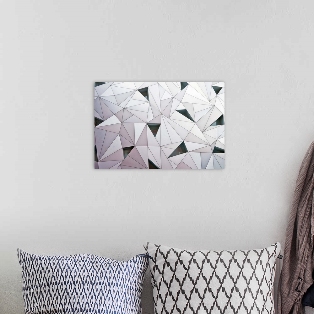 A bohemian room featuring Abstract wall made of triangular shapes on a building in Madrid.