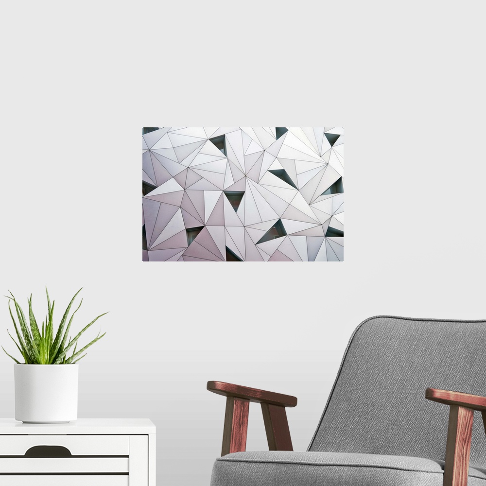 A modern room featuring Abstract wall made of triangular shapes on a building in Madrid.