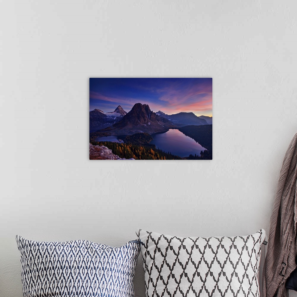 A bohemian room featuring View of two lakes and a snowy mountain range at sunset, with a pastel sky.