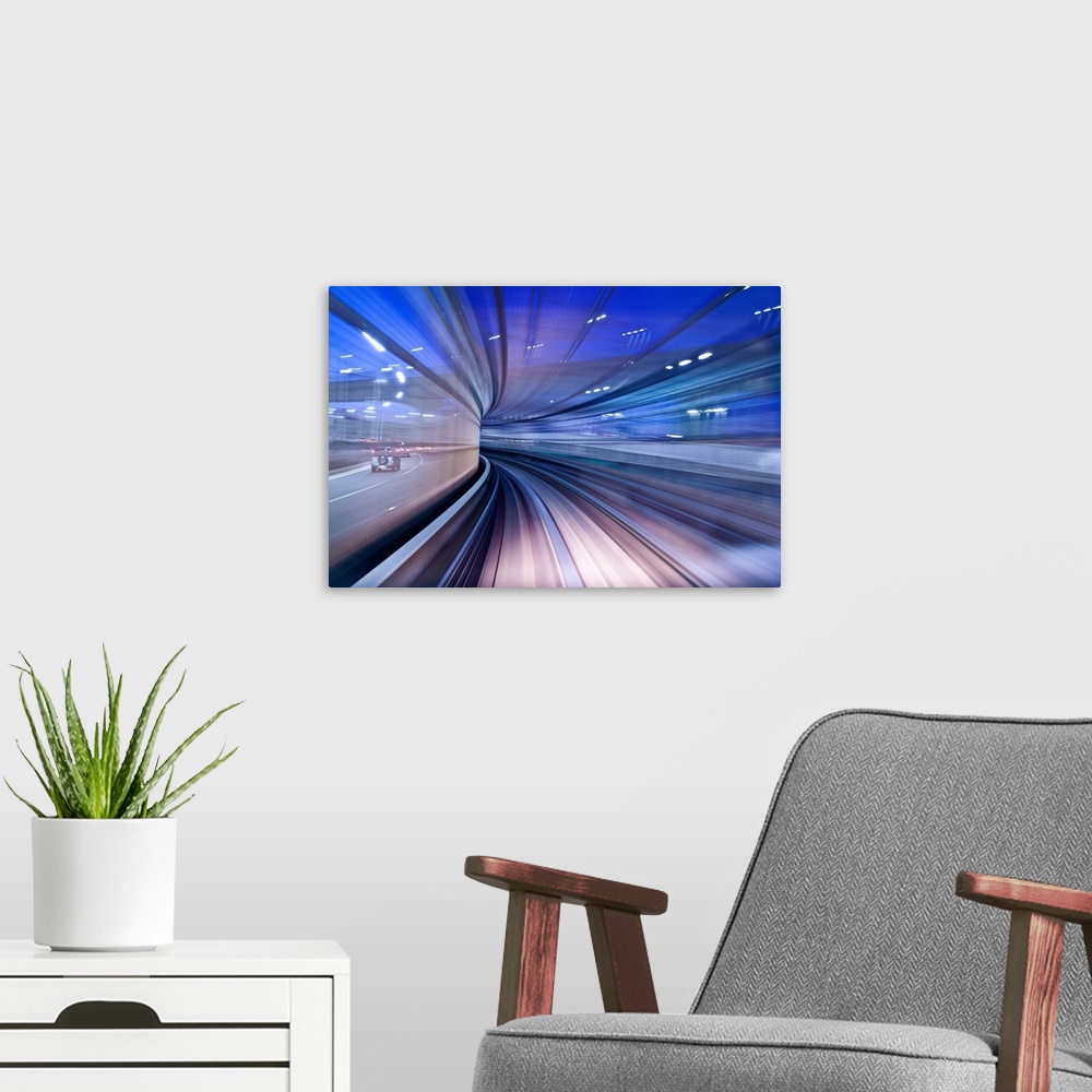 A modern room featuring Blurred motion image of a highway in the evening, creating the illusion of being in a tunnel.
