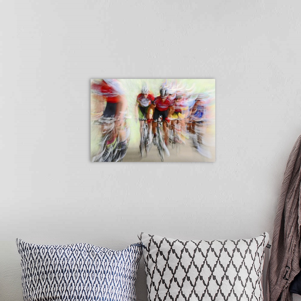 A bohemian room featuring Action photograph of a cyclists in a blur of fast motion.