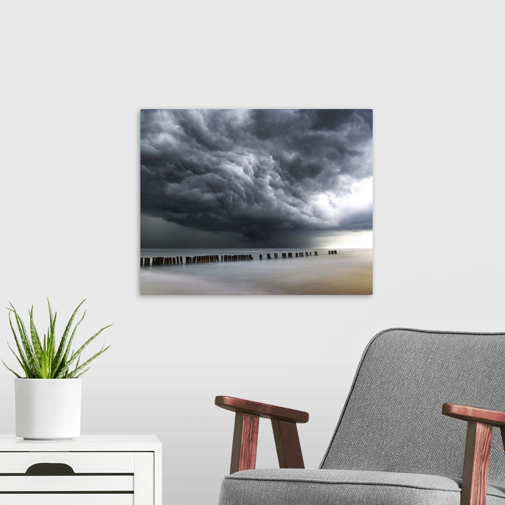 A modern room featuring Photograph of dark, dramatic clouds rolling in over the ocean before a thunderstorm.