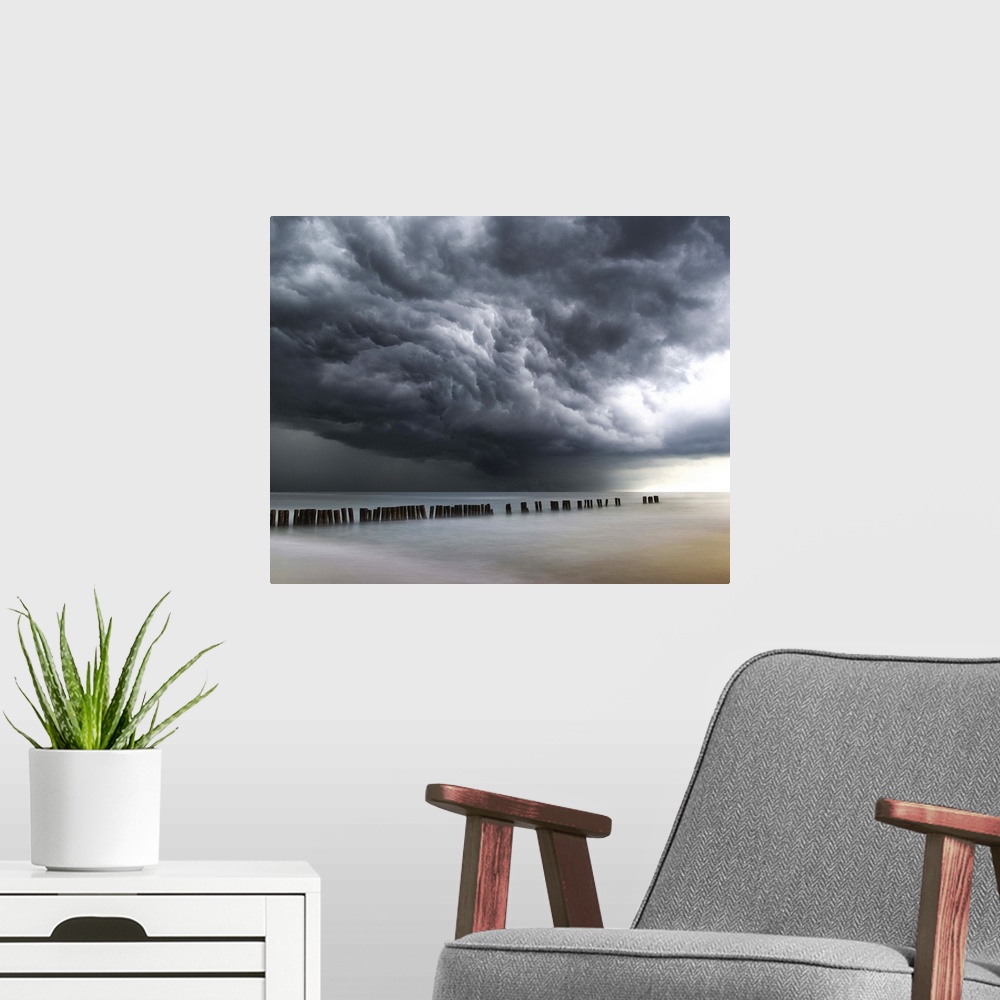 A modern room featuring Photograph of dark, dramatic clouds rolling in over the ocean before a thunderstorm.