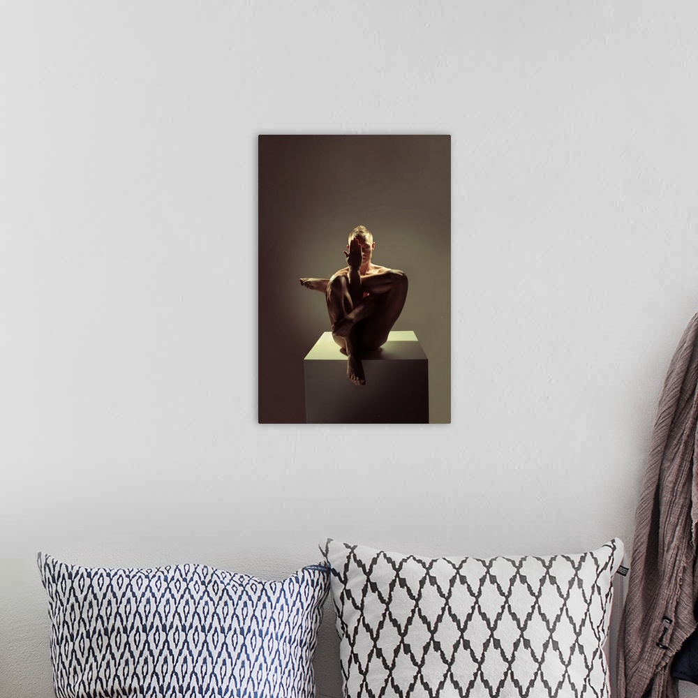 A bohemian room featuring Fine art portrait of a woman sitting on a platform creating angles with her body with dramatic li...
