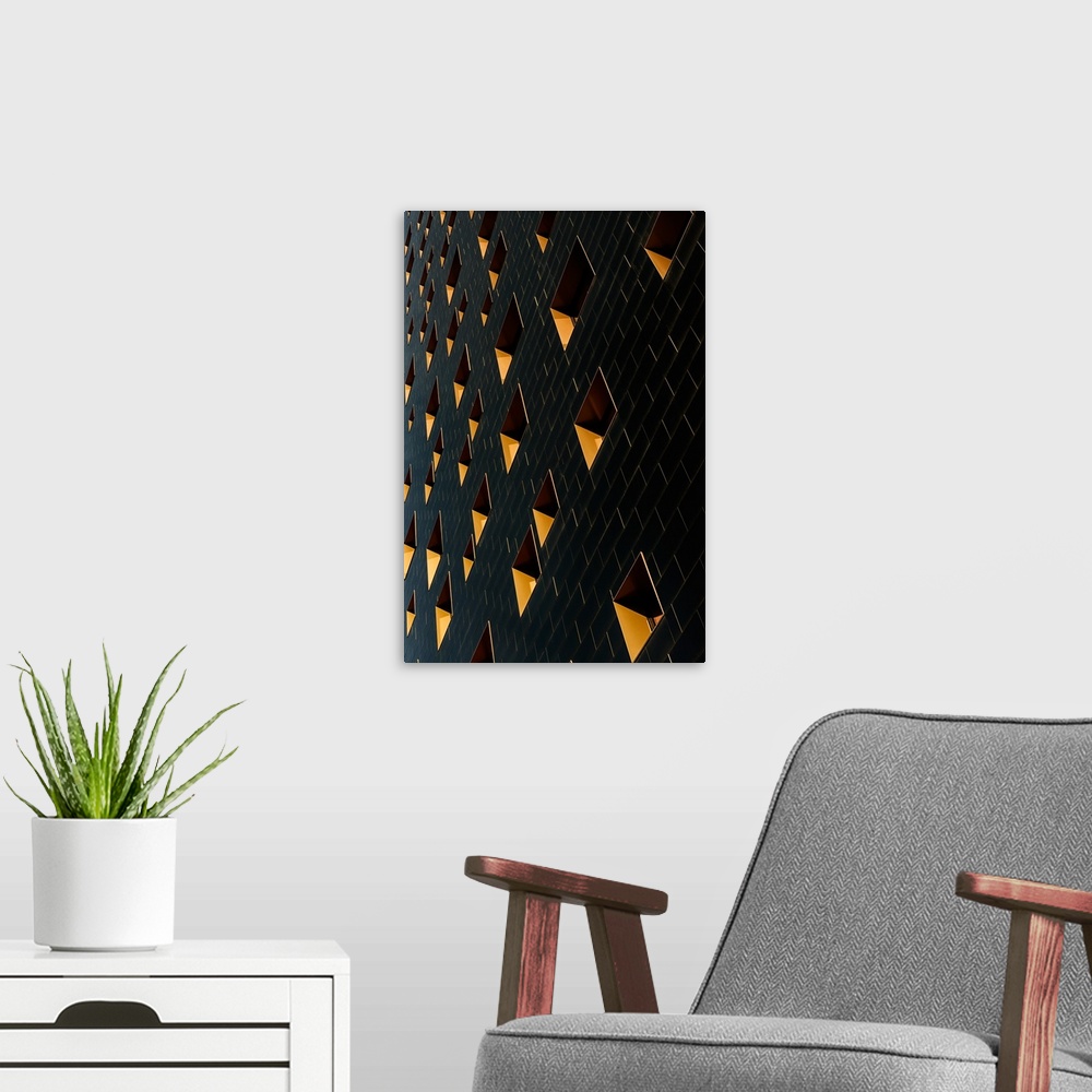 A modern room featuring Architectural abstract photograph of a building facade with black rectangular tiles and yellow wi...