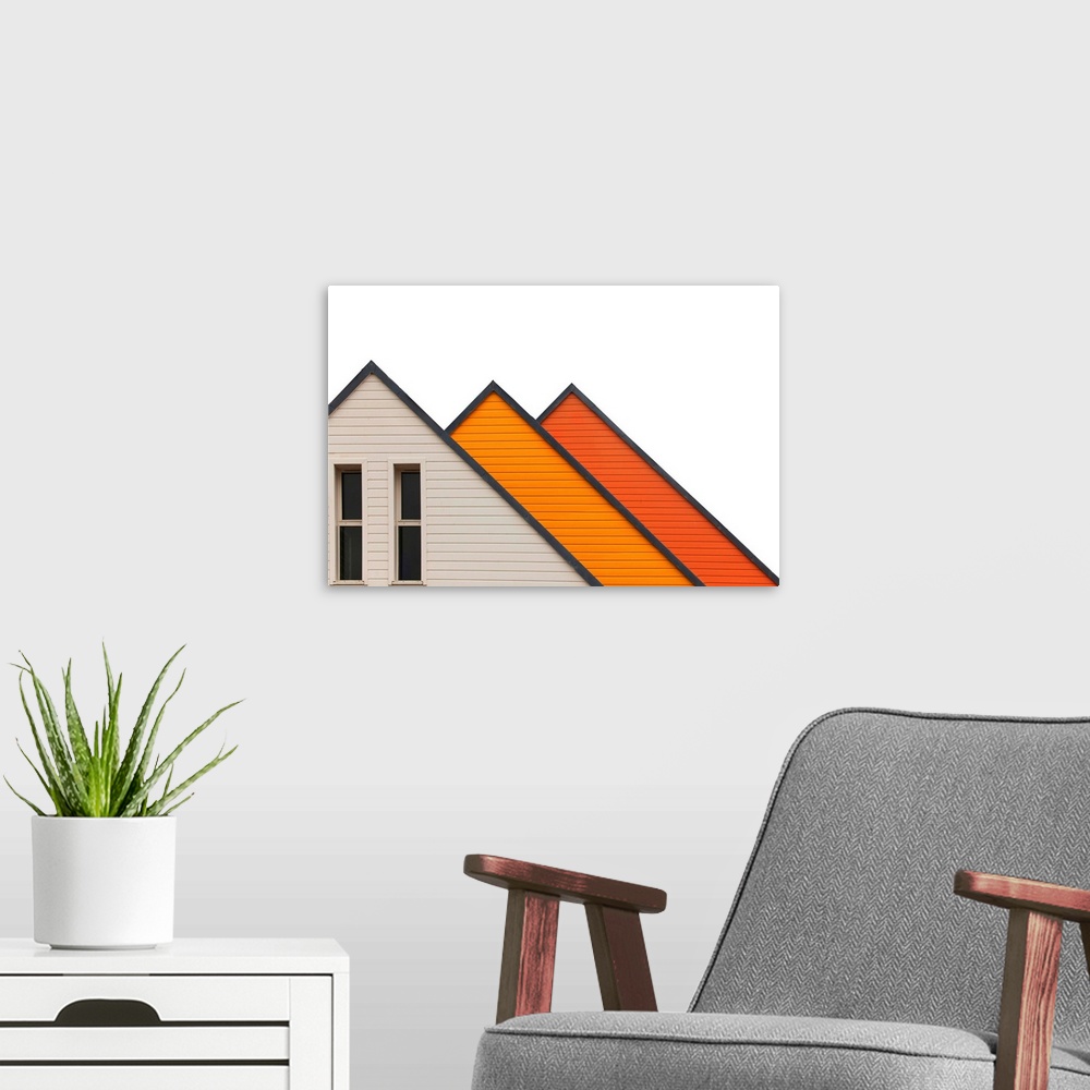 A modern room featuring Architectural abstract photograph of three a-frame structures in white and shades of orange.