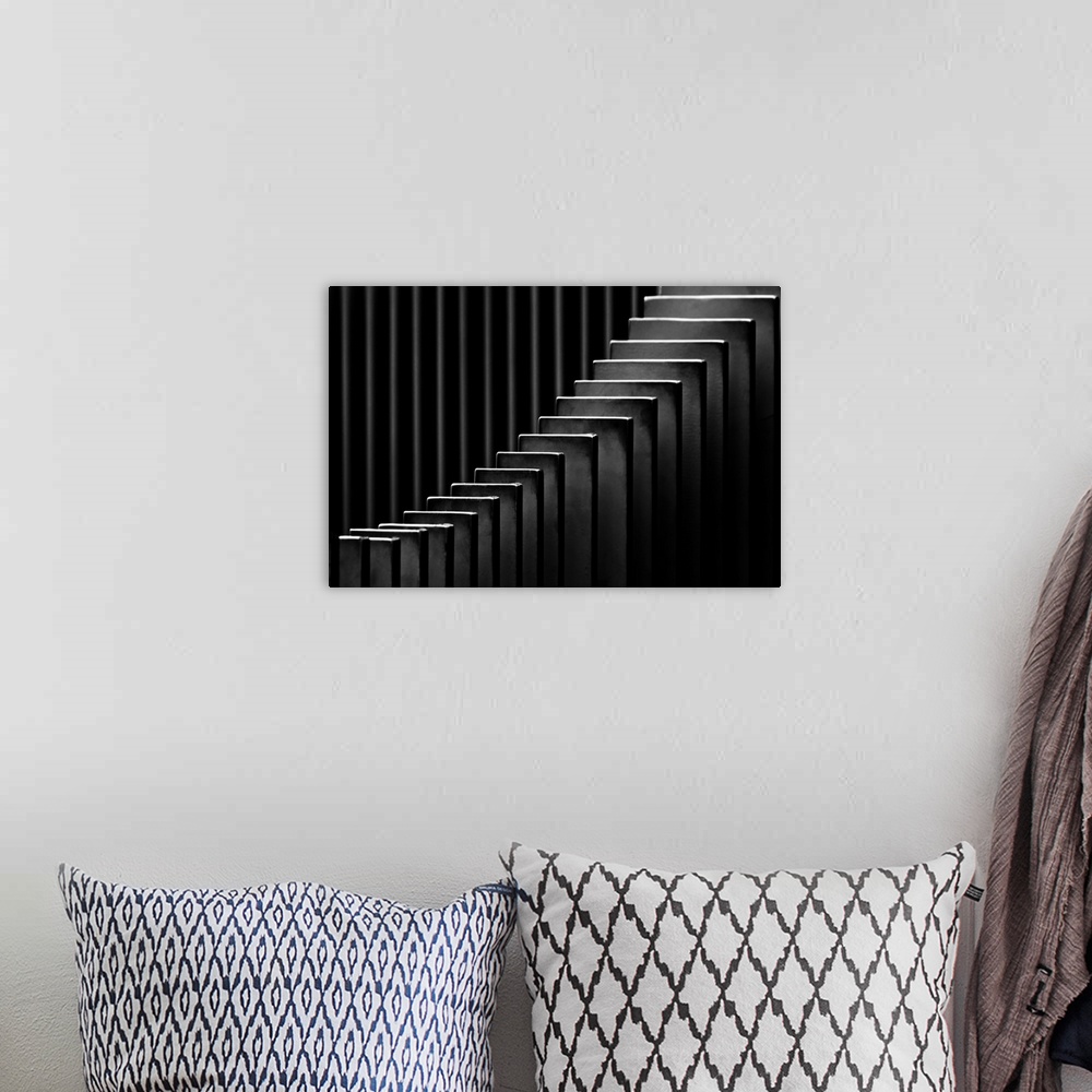 A bohemian room featuring Abstract black and white photograph with leading lines made up of rectangular slits.
