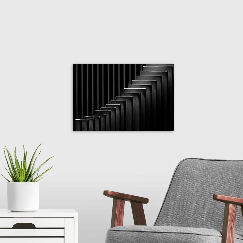 A modern room featuring Abstract black and white photograph with leading lines made up of rectangular slits.