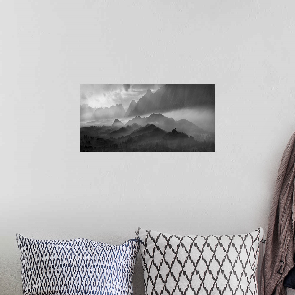 A bohemian room featuring Black and white image of a misty mountain landscape.