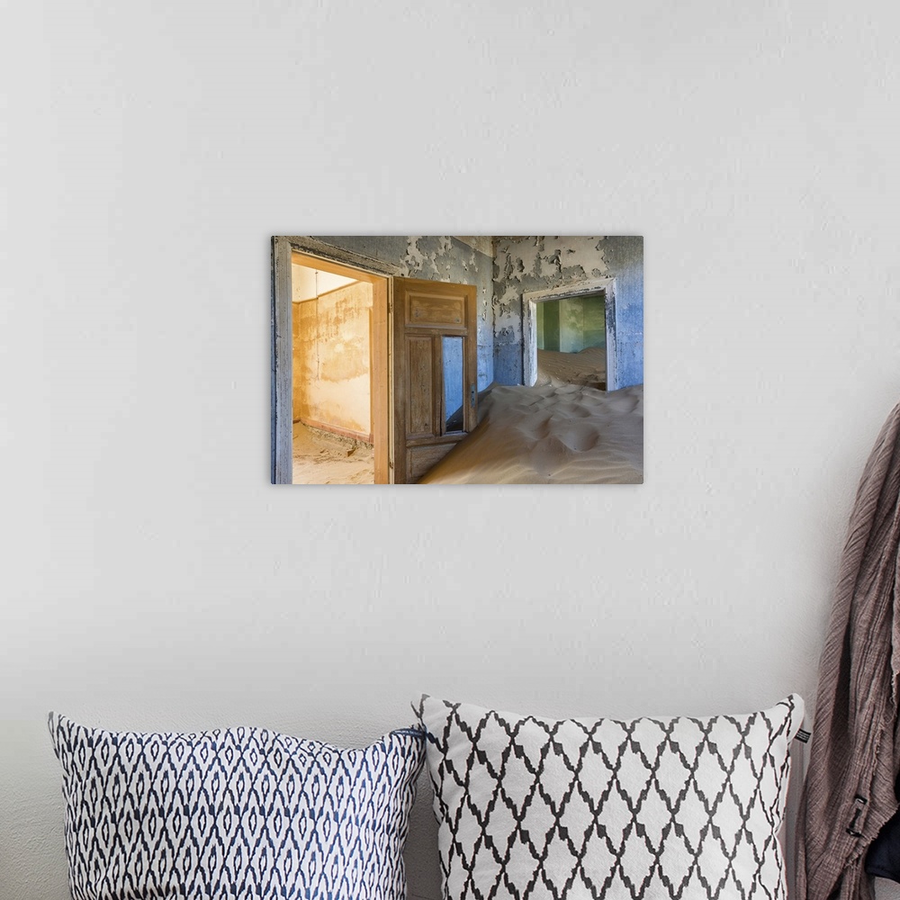 A bohemian room featuring Photograph of an abandoned home interior now filled with the desert sand.