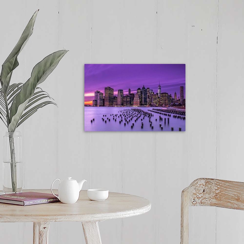 A farmhouse room featuring Manhattan skyline at sunset under a purple sky, seen from Brooklyn.