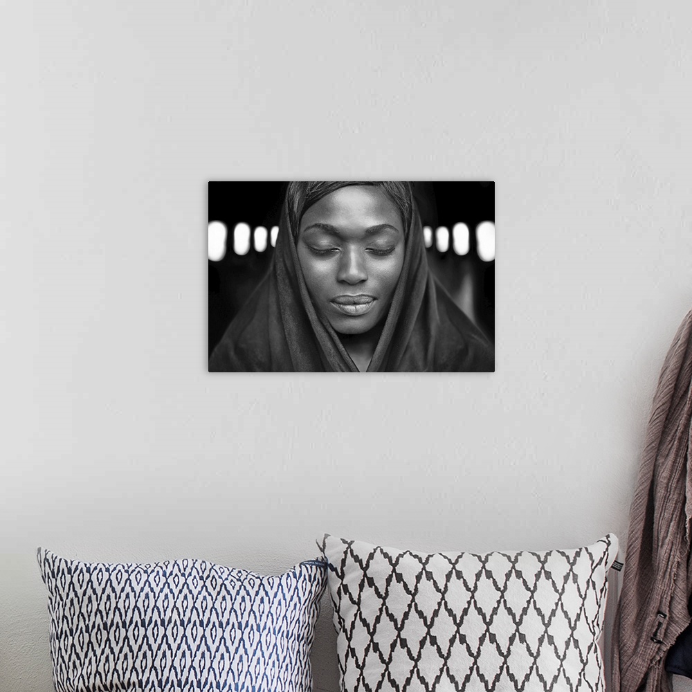 A bohemian room featuring Black and white portrait of a beautiful dark-skinned woman with eyes closed.