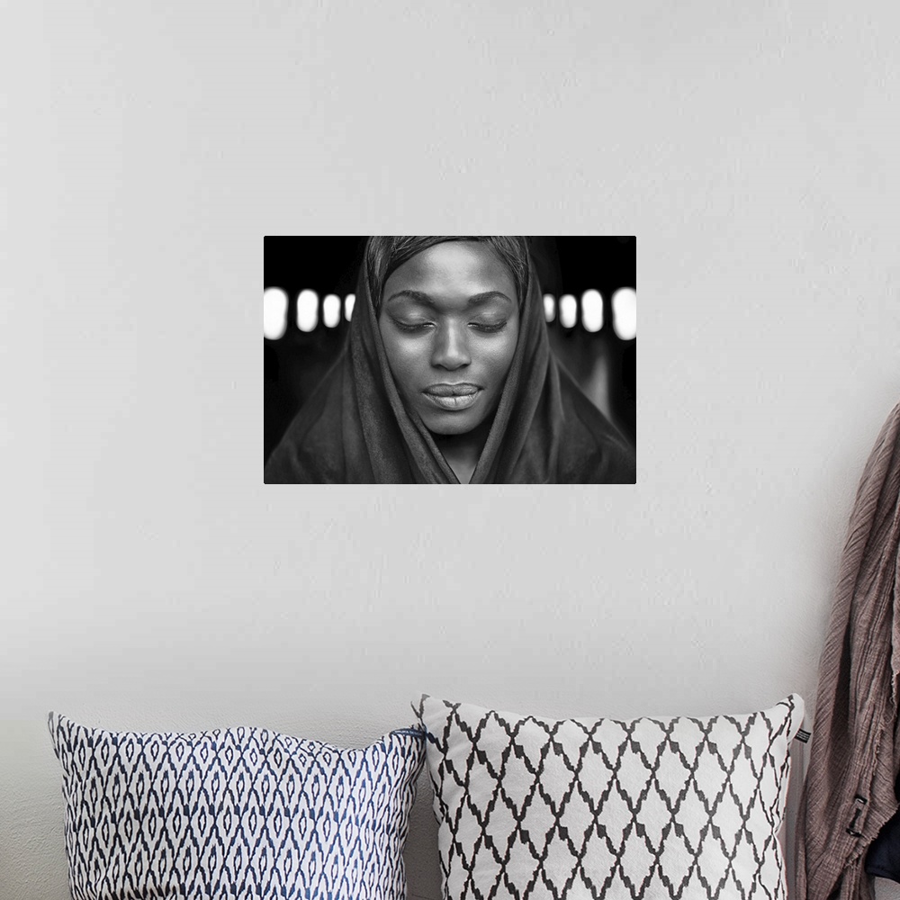 A bohemian room featuring Black and white portrait of a beautiful dark-skinned woman with eyes closed.