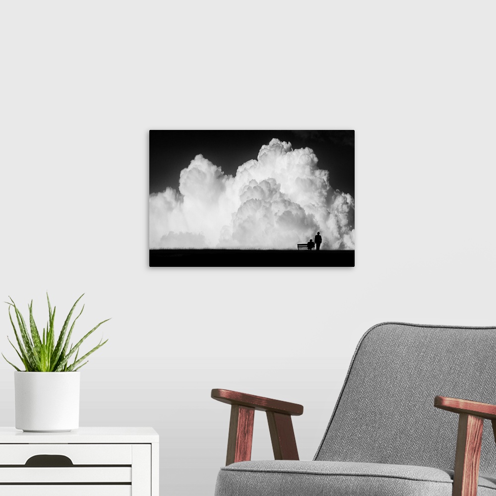 A modern room featuring Figures and a bench dwarfed by gigantic stormclouds in the sky.