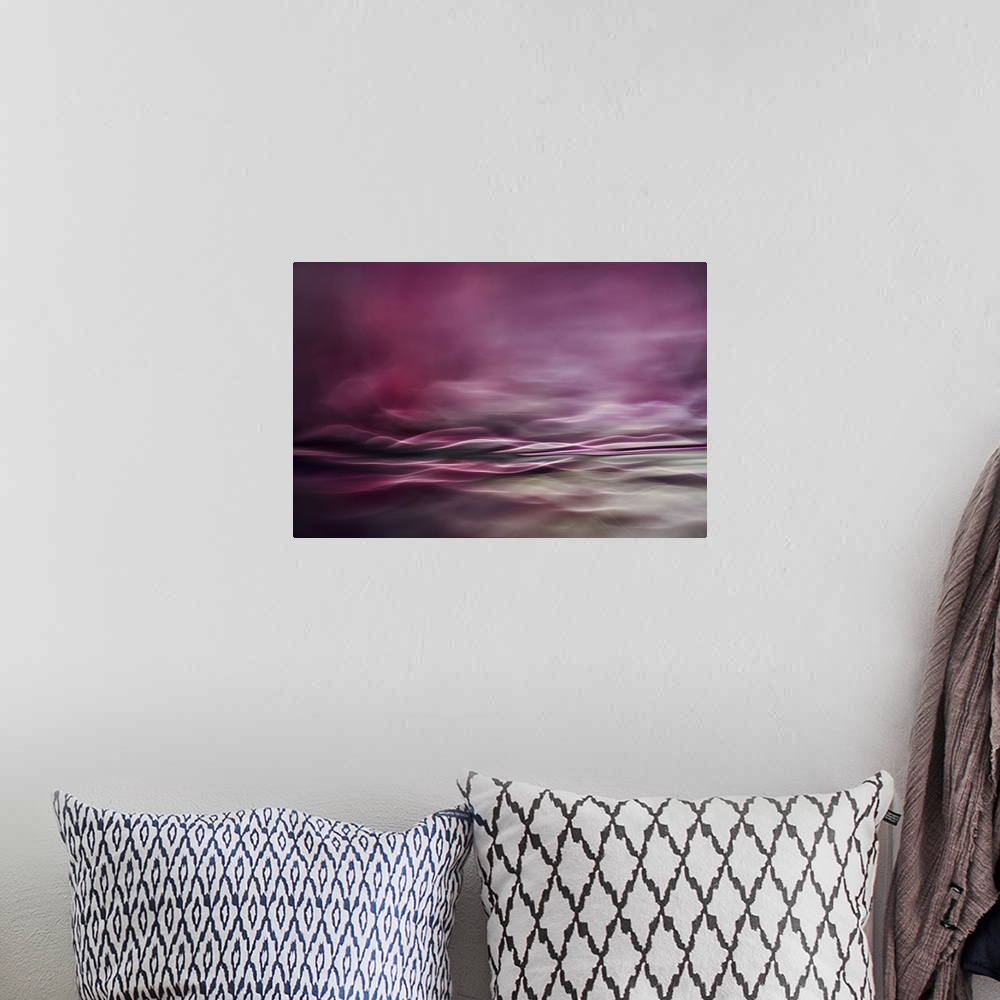 A bohemian room featuring Abstract digital art with pink and gray hues and curvy lines creating movement.