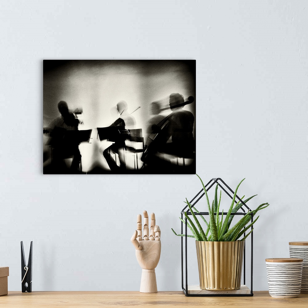 A bohemian room featuring Motion blur image of a string quartet playing.