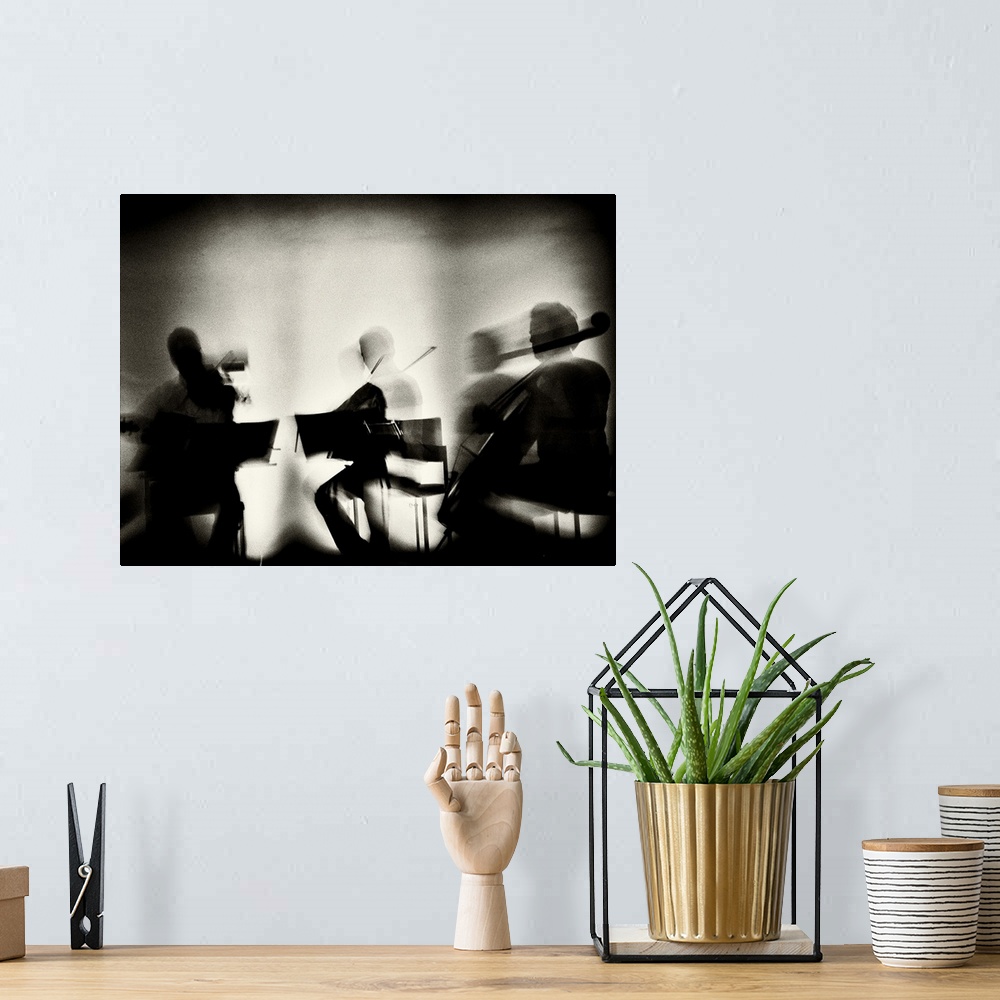 A bohemian room featuring Motion blur image of a string quartet playing.