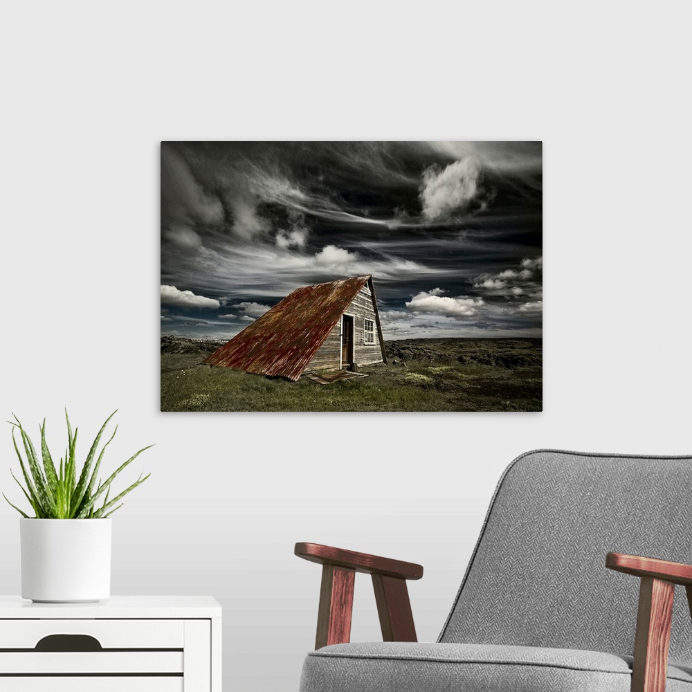 A modern room featuring An abandoned shack in Iceland under a blanket of wispy clouds.